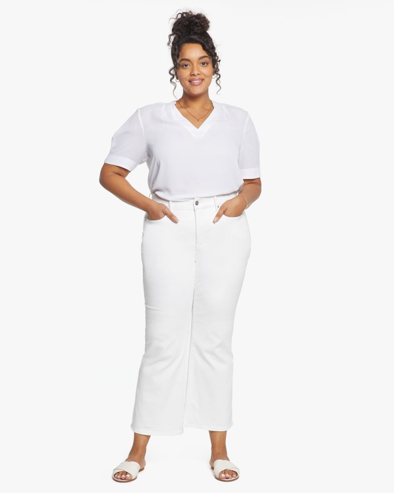 Front of a model wearing a size 0X Waist Match Relaxed Flare Jean in Optic White by NYDJ. | dia_product_style_image_id:187668